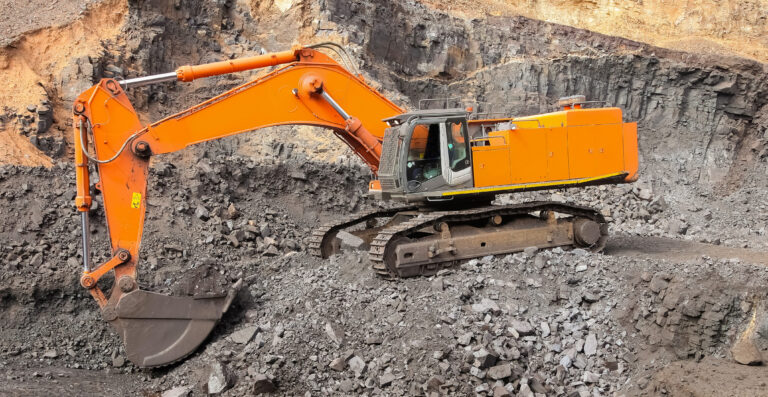 Yellow excavator at mining site - heavy equipment leasing